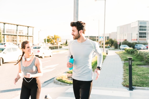 Smiling people running on crosswalk