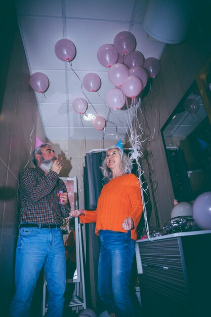 Smiling portrait of senior couple celebrating the birthday party