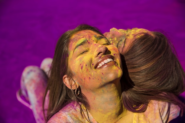 Smiling portrait of a young woman sitting back to back