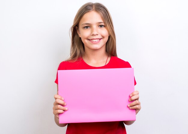 Smiling schoolgirl showing empty copybook