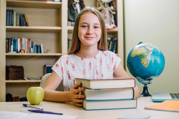 Smiling schoolgirl with books