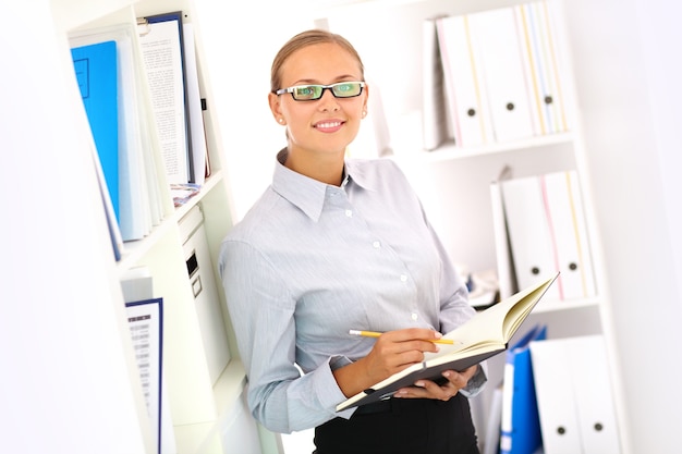 Free photo smiling secretary with open notebook