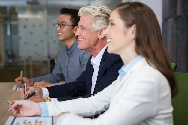 Free photo smiling senior businessman sitting at conference