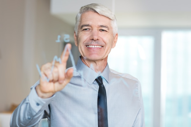 Smiling Senior Businessman Touching Glass Screen