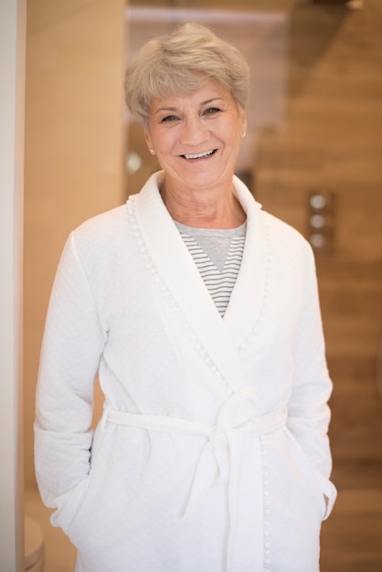 Smiling senior woman in the bathrobe