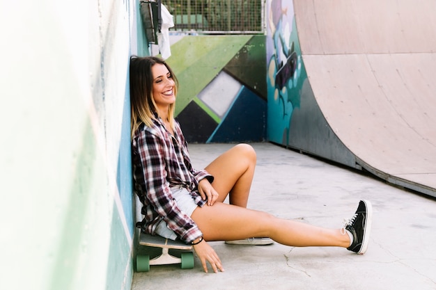 Smiling skater girl on skateboard