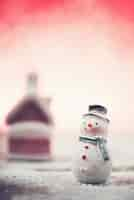 Free photo smiling snowman with snow and bright background