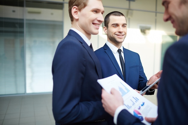 Free photo smiling specialist checking the financial report