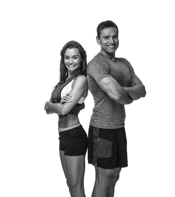 Smiling sporty couple isolated on a white background.