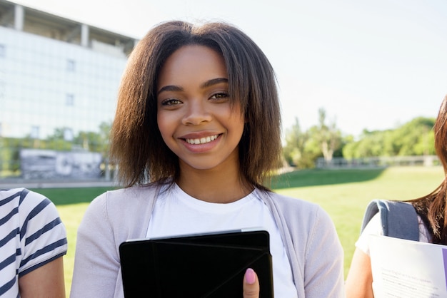 Smiling student african woman standing outdoors