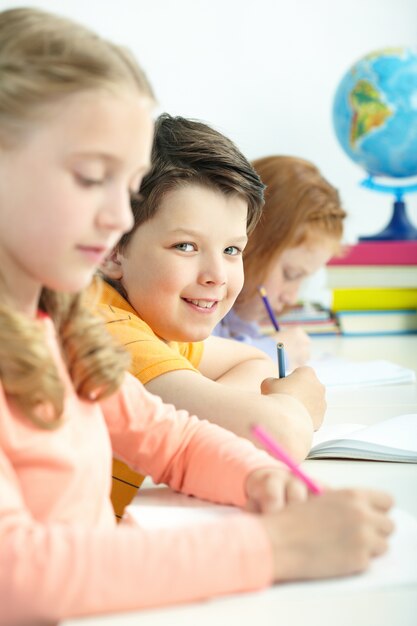 Smiling student holding a pencil