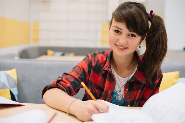 Smiling student studying in class