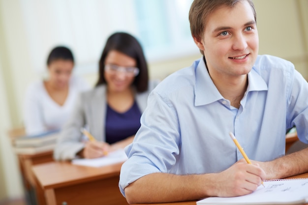 Smiling students sitting in row