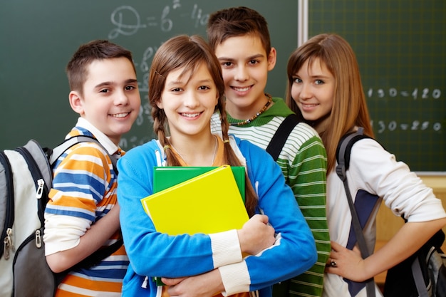 Free photo smiling students with backpacks