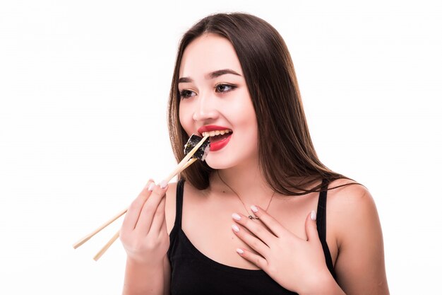 Smiling surprised asian woman taste sushi rolls dressed in black red lips isolated