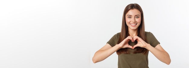 Free photo smiling teenager girl making heart shape with her hands isolated on white