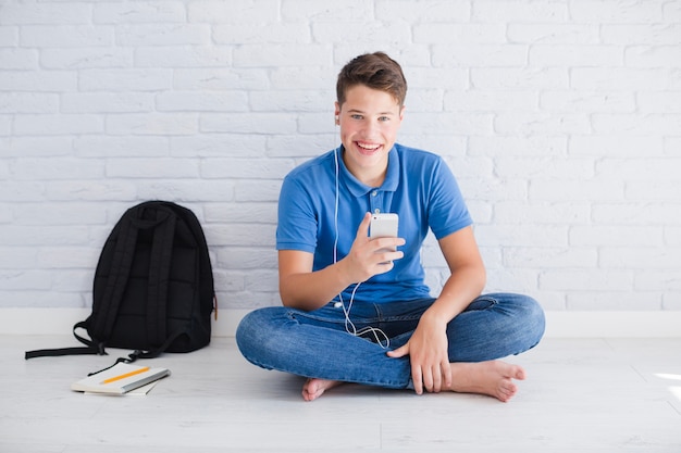 Smiling teenager listening to music