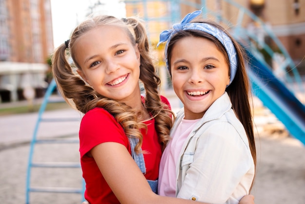 Smiling two girls hugging each other