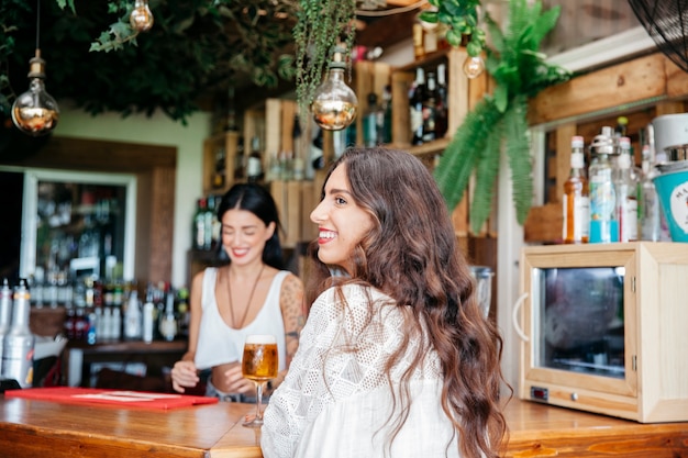 Smiling woman and bartender