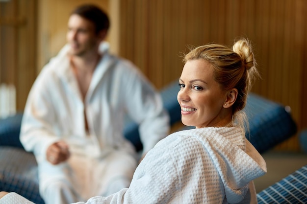 Free photo smiling woman in bathrobe and her husband enjoying a day at wellness center