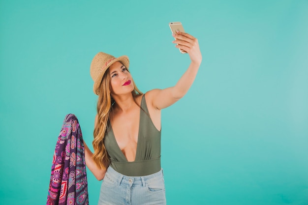 Smiling woman in beachwear taking a selfie