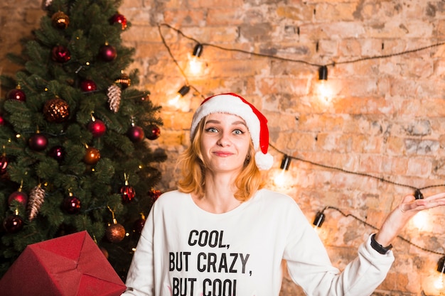 Free Photo smiling woman in front of christmas tree