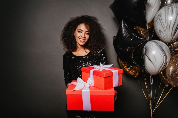 Smiling woman holding birthday present