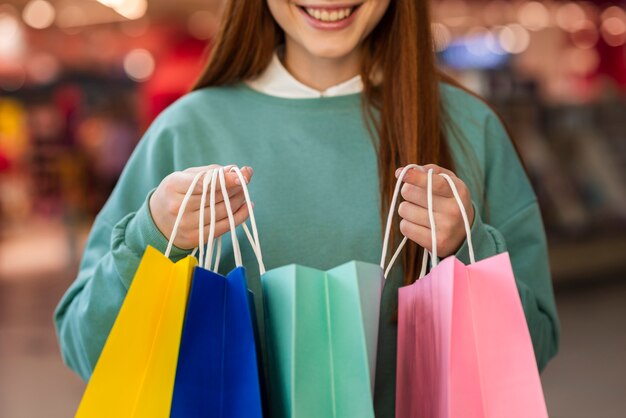 Smiling woman holding colorful paper bags