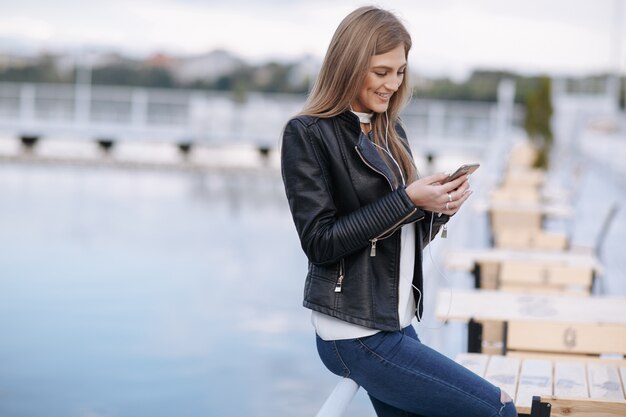 Smiling woman looking at her smart phone