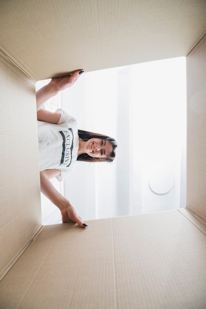 Free photo smiling woman looking inside box