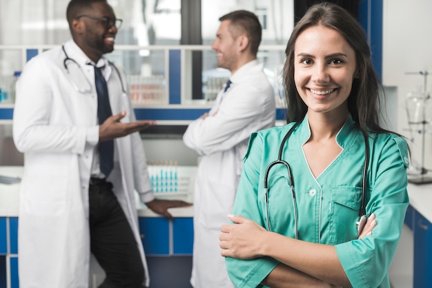 Smiling woman medic with arms crossed