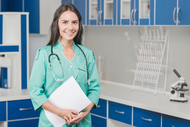 Free photo smiling woman medic with papers