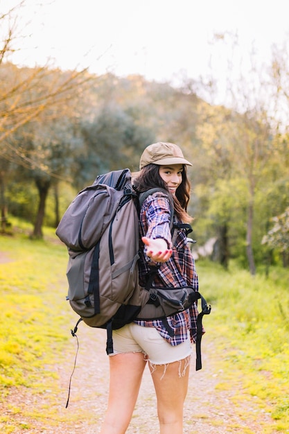 Smiling woman offering to follow her