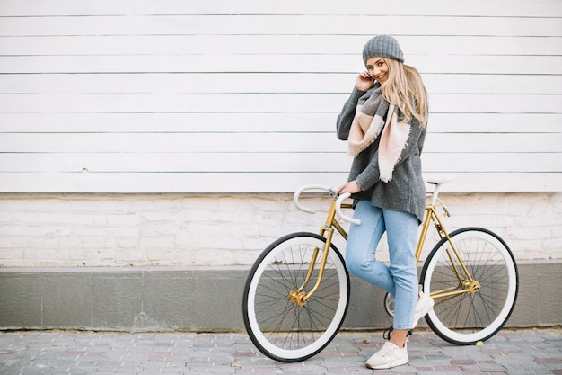 Smiling woman posing with bicycle