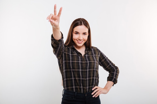 Smiling Woman in shirt showing peace sign