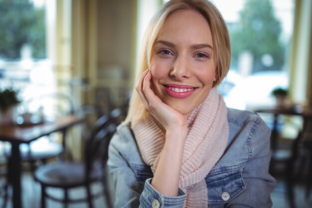 Smiling woman sitting in cafÃ©