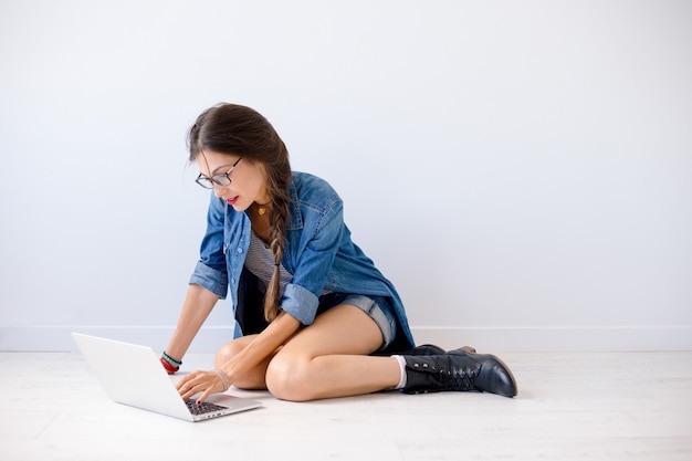 Smiling woman typing on laptop