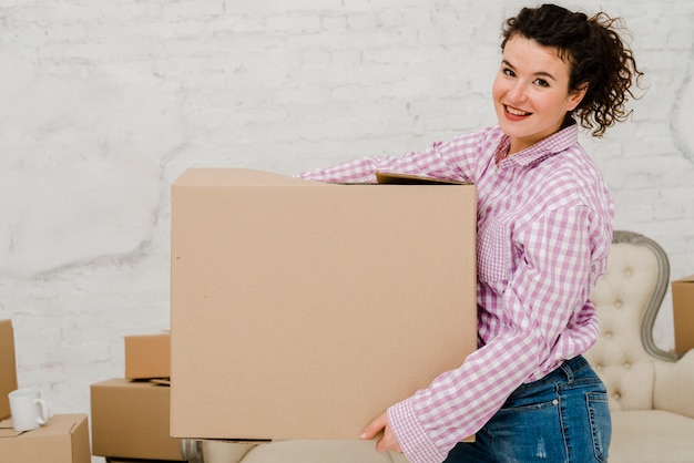 Free Photo smiling woman with big box