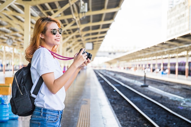 Smiling woman with camera on depot 