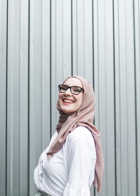 Free photo smiling woman with glasses and hijab