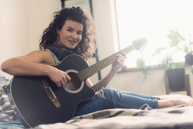 Smiling woman with guitar