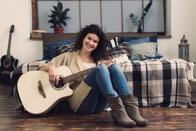 Smiling woman with guitar