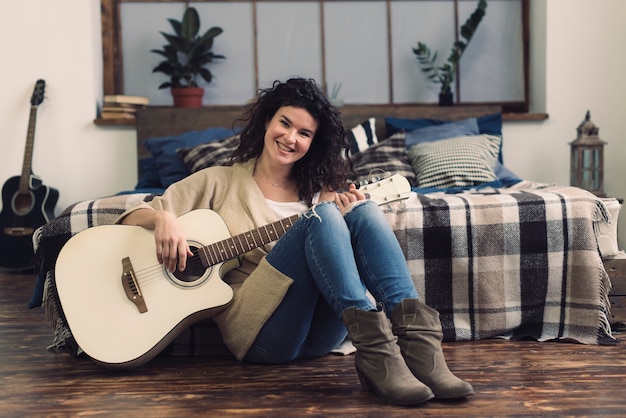 Smiling woman with guitar