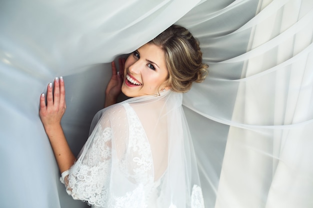 Free photo smiling woman with white curtains