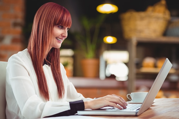 Smiling woman working with her laptop