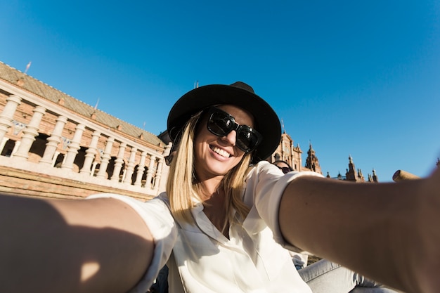 Free photo smiling women taking selfie in old city