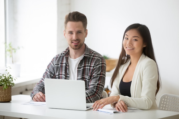 Smiling young asian businesswoman and businessman professionals team portrait