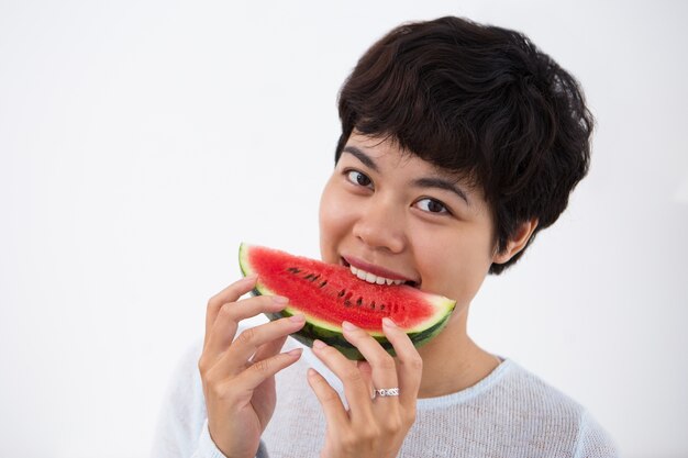 Smiling Young Asian Woman Biting Watermelon