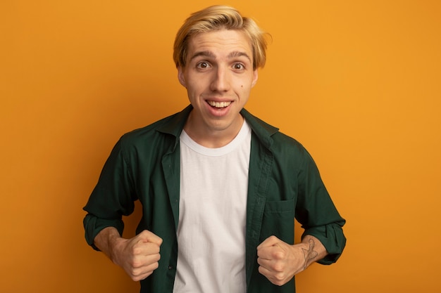 Free Photo smiling young blonde guy wearing green t-shirt showing yes gesture