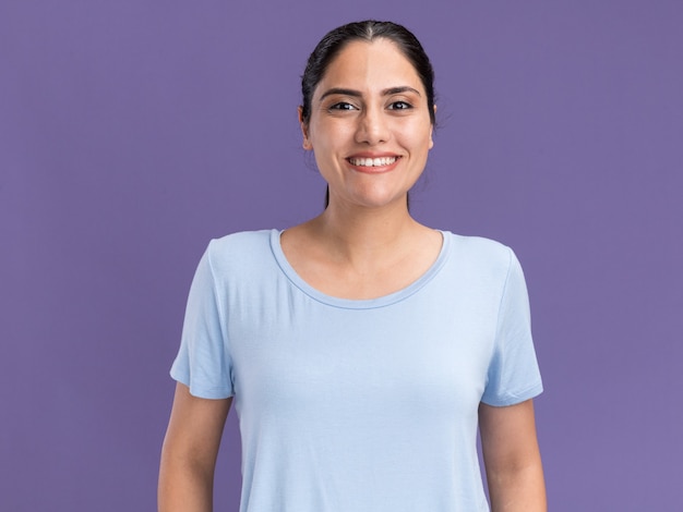 Smiling young brunette caucasian girl looks at camera